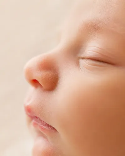 Close-up newborn profile highlighting nose shape